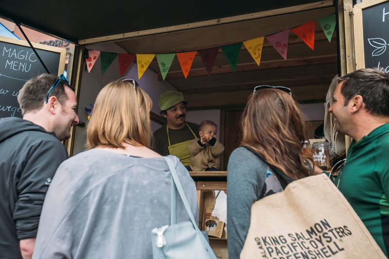 People crowded round a market stall